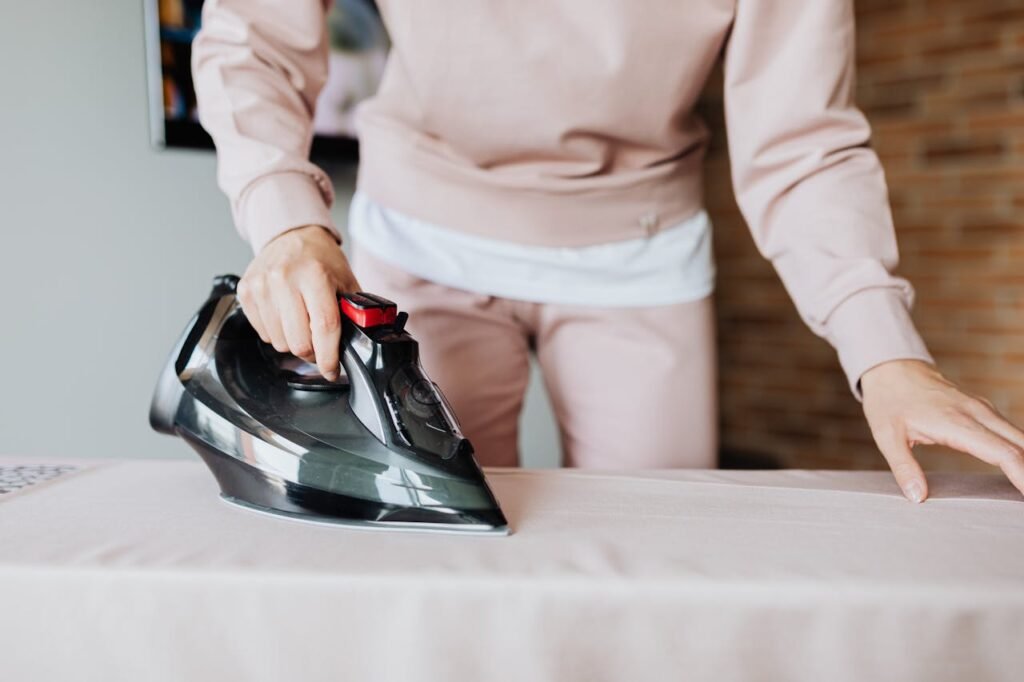 Person Ironing a Fabric